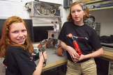 Camille (right) and Genevieve Beatty in the Beatty Robotics Lab. Their Mars rover, commissioned by the New York Hall of Science, stands on the workbench. The rover was installed at the NY Hall of Science on June 8, 2013.