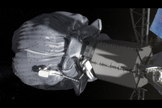 In this conceptual image, the two-person crew uses a translation boom to travel from the Orion spacecraft to the captured asteroid during a spacewalk. Image released Aug. 22, 2013.