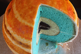The planet's core is made from mud cake, almond butter represents a layer of liquid metallic hydrogen and the blue-colored vanilla Madeira sponge cake is representative of molecular hydrogen. Image uploaded on Aug. 27, 2013.
