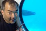 JAXA astronaut Soichi Noguchi in the Aquarius underwater laboratory, with a barracuda in the background. Noguchi was on the SEATEST crew that worked in the lab in September 2013.
