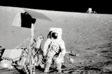 The Apollo 12 Commander examines the unmanned Surveyor III spacecraft during the second extravehicular activity in 1969.