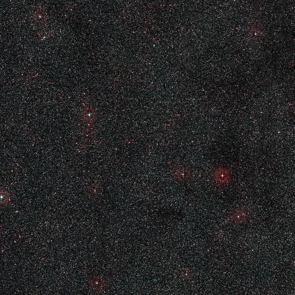 This wide-field image shows the patch of sky around the distant active galaxy PKS 1830-211. This view was created from photographs forming part of the Digitized Sky Survey 2. Image released Oct. 16, 2013.