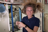 NASA astronaut Karen Nyberg demonstrates how a single strand of hair can be used to move in the microgravity environment of space in a video recorded on the International Space Station in October 2013.