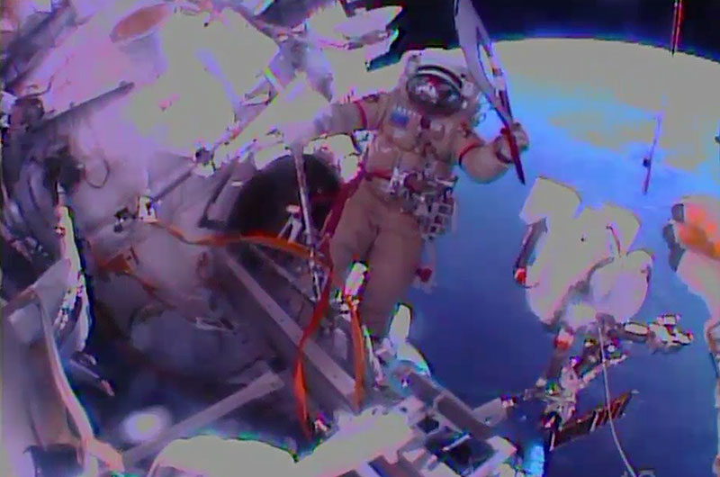 Cosmonaut Oleg Kotov Spacewalks with Olympic Torch