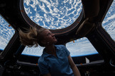 NASA astronaut Karen Nyberg enjoys the view of Earth from the windows in the Cupola of the International Space Station during her Expedition 37 mission in 2013. Image taken Nov. 4.