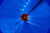 Comet ISON comes in from the bottom right and moves out toward the upper right, getting fainter and fainter, in this time-lapse image from the ESA/NASA Solar and Heliospheric Observatory on Nov. 28, 2013. The image of the sun at the center is from NASA's Solar Dynamics Observatory.