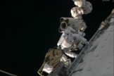 NASA astronaut Rick Mastracchio stands on the International Space Station's robotic arm during an urgent spacewalk to fix the station's vital cooling system.