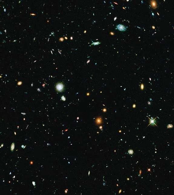 This long-exposure Hubble Space Telescope image of massive galaxy cluster Abell 2744 is the deepest ever made of any cluster of galaxies. It shows some of the faintest and youngest galaxies ever detected in space. Abell 2744, located in the constellation Sculptor, appears in the foreground of this image. It contains several hundred galaxies as they looked 3.5 billion years ago. The immense gravity in Abell 2744 acts as a gravitational lens to warp space and brighten and magnify images of nearly 3,000 distant background galaxies.