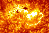 This NASA view combines two images from NASA's Solar Dynamics Observatory captured on Jan. 7, 2014. Together, the images show the location of a giant sunspot group on the sun, and the position of an X-class flare that erupted at 1:32 p.m. EST.