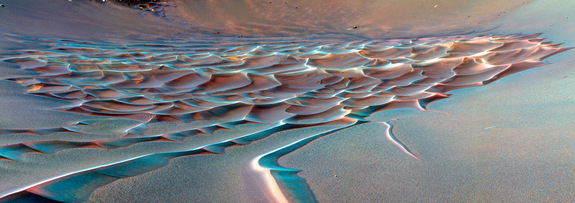 Ralph Bagnold, an early pioneer of dune studies, remarked that—compared to the nearly static chaos that seems to characterize slowly crumbling, weathering landscapes—sand dunes can “move inexorably, in regular formation, over the surface of the country, growing, retaining their shape, even breeding, in a manner which by its grotesque imitation of life, is vaguely disturbing to an imaginative mind.”
