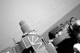 Using its navigation camera, Curiosity looks down at its front-right wheel just after the rover reached the peak of the dune on Feb. 4, 2014.