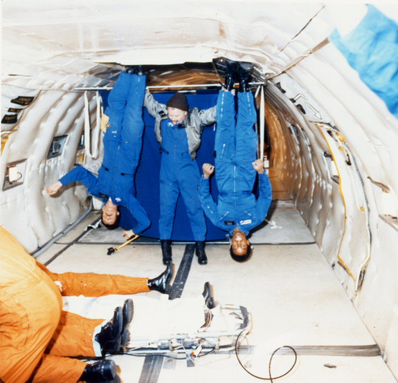 Astronaut Guion S. Bluford and Aviation Safety Officer Charles F. Hayes get a unique perspective of the environment during a 1979 zero gravity flight.