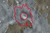 A daytime view of the area surrounding Mojave Crater, shown in a picture taken by Mars Odyssey. Mojave Crater is circled in red. Craters were counted for the plateau units (brown), channel units (blue-grey) and ejecta from Mojave (red line).