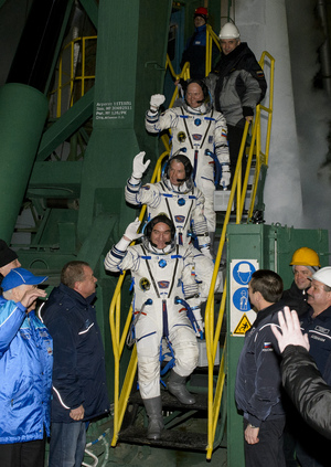 Expedition 39 Soyuz Commander Alexander Skvortsov of the Russian Federal Space Agency, Roscosmos, bottom, Flight Engineer Steve Swanson of NASA, middle, and Flight Engineer Oleg Artemyev of Roscosmos, wave farewell prior to boarding the Soyuz TMA-12M rocket for launch, Wednesday, March 26, 2014 local time (March 25 EDT) at the Baikonur Cosmodrome in Kazakhstan.