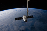 A SpaceX Dragon commercial cargo craft is seen in the the grips of the Canadarm2 before being released May 31, 2012. The space station's robotic arm is used to capture and release SpaceX Dragon cargo ships during their resupply missions.