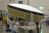 NASA workers at the agency's Jet Propulsion Laboratory, wearing clean room "bunny suits," prepare the LDSD test article for shipment later this month to Hawaii. LDSD will help land bigger space payloads on Mars or return them back to Earth.