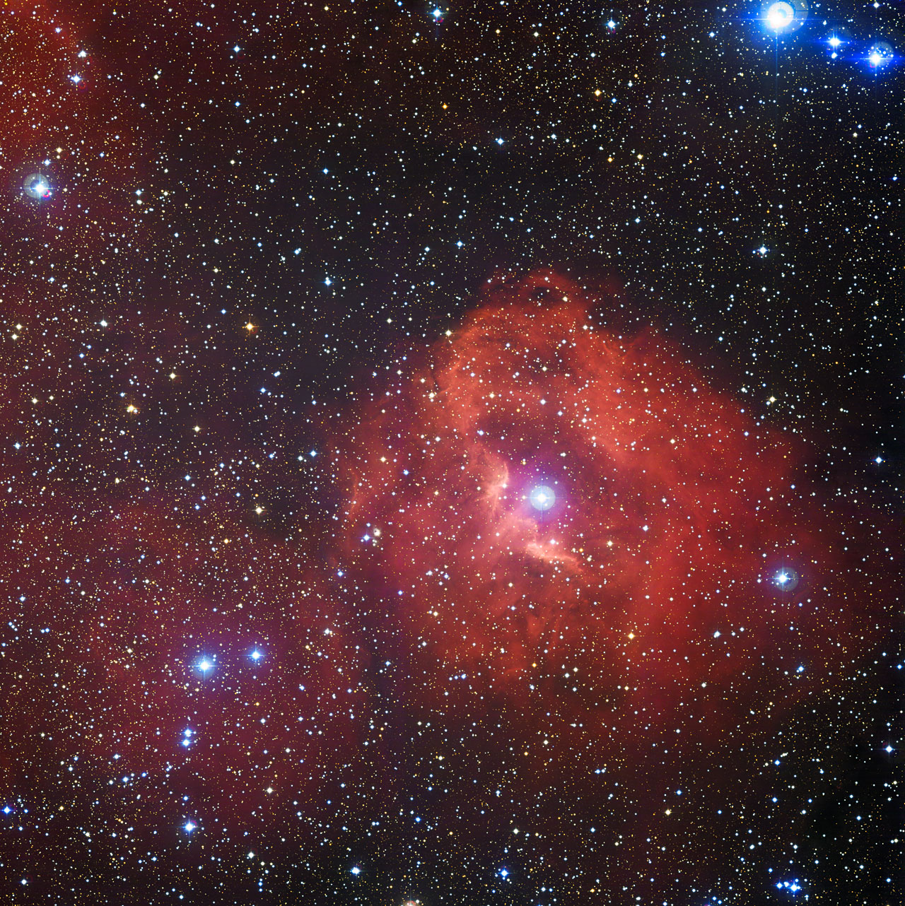 Rosy Cosmic Cloud Glows with Stars in New Telescope View