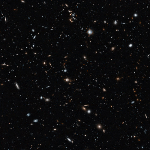 An image of a galaxy cluster taken by the NASA/ESA Hubble Space Telescope gives a remarkable cross-section of the Universe, showing objects at different distances and stages in cosmic history. They range from cosmic near neighbours to objects seen in the early years of the Universe. The 14-hour exposure shows objects around a billion times fainter than can be seen with the naked eye.