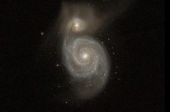 This visible light image of Messier 51 shows details that are obscured by dust in the GALEX ultraviolet image.