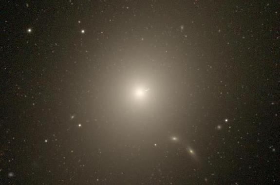 Messier 87 is redder and more massive than the Milky Way.