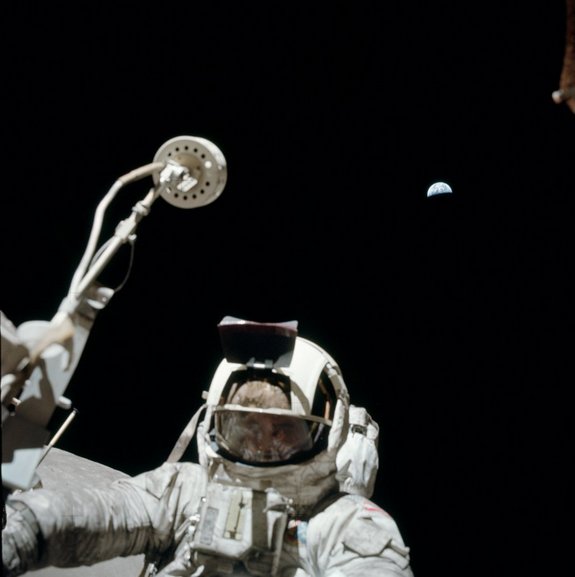 Apollo 17's Harrison "Jack" Schmitt poses with Earth in background during his exploration of the moon's Taurus-Littrow valley.