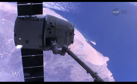SpaceX's Dragon capsule flies above Angola while attached to the International Space Station just before its release on May 18, 2014.