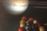 Jupiter's immense gravity keeps the dust particles shed by Comet 209P/LINEAR packed relativty close together. Somewhat similar to a cosmic game of pool, when the comet and its accompanying particles pass near Jupiter, the big planet "re-racks" the particles.