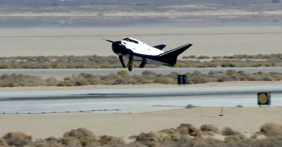 Dream Chaser space plane built by Sierra Nevada Corp. landed with its left landing gear undeployed in this still from an Oct. 26, 2013, unmanned drop test at Edwards Air Force Base in California. The malfunction caused the prototype to skid off the runway.