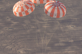 A test version of NASA’s Orion spacecraft touches down in the Arizona desert after its most complicated parachute test to date.