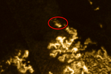 The strange anomaly in Titan's seas is circled in red.
