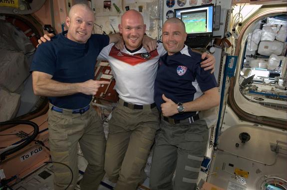 From left to right: NASA's Steve Swanson, German astronaut Alexander Gerst and NASA's Reid Wiseman line up after Gerst shaved both NASA astronauts' heads to even a bet the NASA astronauts lost after the United States lost to Germany in a World Cup match on June 26, 2014.