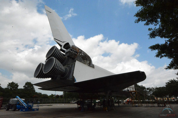 The exterior of the replica shuttle Independence at Space Center Houston is receiving a new skin, including the replacement of the numbered heat shield tiles that line its underbody. <a href="http://www.collectspace.com/news/news-070314b-inside-space-shuttle-independence.html">Click here for more photos</a>.