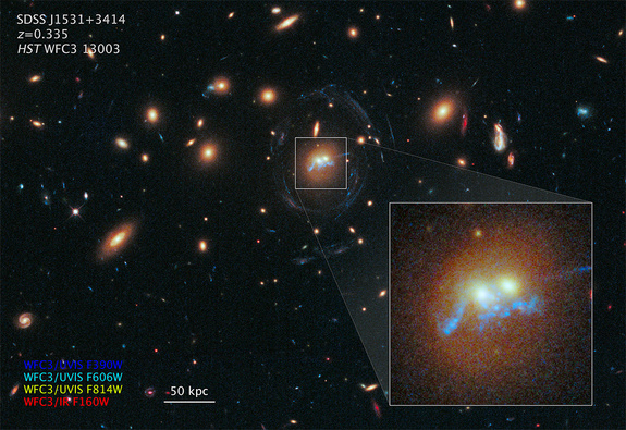 An image by NASA's Hubble Space Telescope shows a 100,000-light-year-long structure that resembles a string of pearls twisted into a corkscrew shape, winding around the cores of two massive galaxies. The "pearls" are actually superclusters of blazing, blue-white, newborn stars.