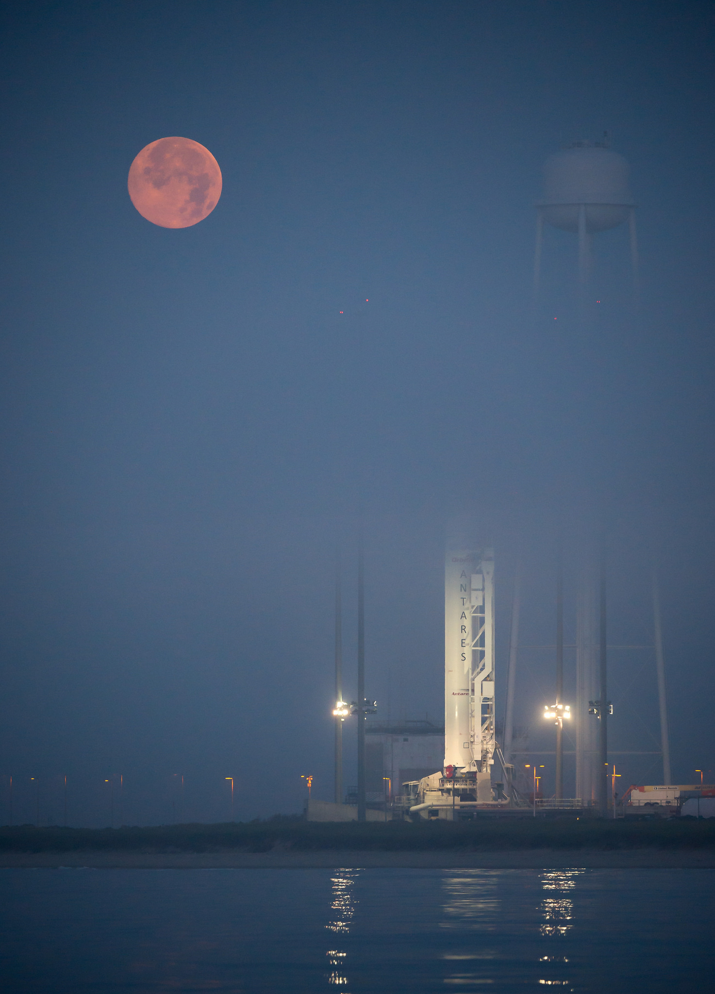 Supermoon Sets Behind Antares Rocket