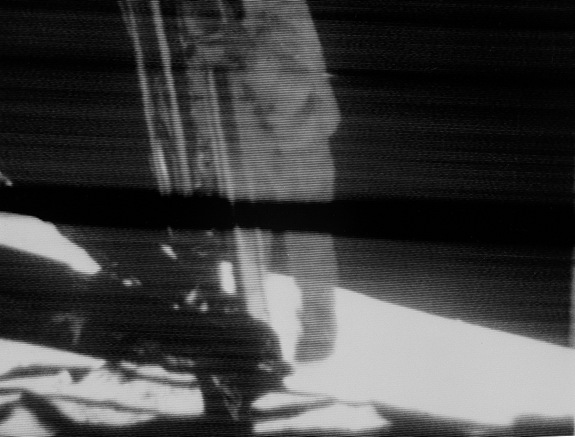 Apollo 11 commander Neil Armstrong descends the ladder on the lunar module Eagle on July 20, 1969 in this still image of a live TV broadcast during the first manned moon landing.