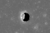 An image from the LRO shows a pit crater on Mare Tranquillitatis, with boulders lying on an otherwise smooth floor.