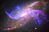 Spiral Galaxy Messier 106 has two extra swirling arms that glow in X-ray, optical and radio light.