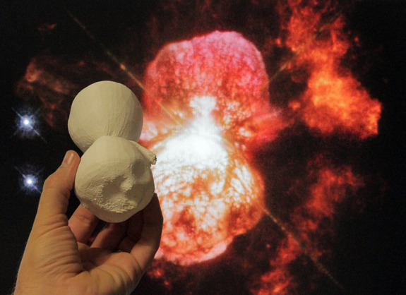 A 3D-printed model of the Homunculus Nebula is compared to a Hubble Space Telescope image of the same object in this NASA photo.