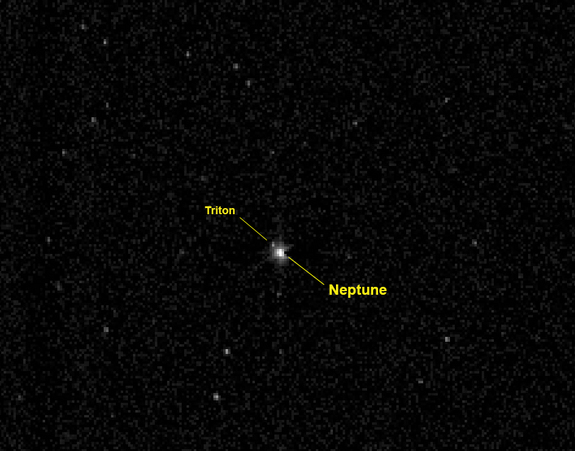 This labeled photo identifies the planet Neptune and its large moon Triton as they appeared to NASA's New Horizons spacecraft on July 10, 2014 from a distance of 2.45 billion miles (3.96 billion km). New Horizons is headed for a 2015 flyby of the dwarf planet Pluto. On Aug. 25, 2014, the probe passed the orbit of Neptune.