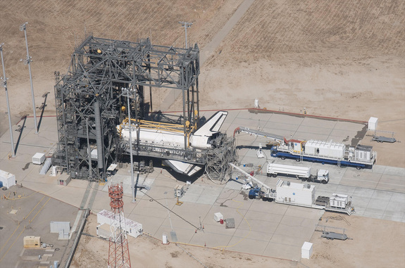 Space Shuttle Discovery is surrounded by the Mate-DeMate Device gantry and ground support equipment at NASA’s Dryden (now Armstrong) Flight Research Center during processing for its ferry flight back to the Kennedy Space Center in Florida after the STS-128 mission in September 2009.