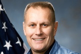 Astronaut Robert Overmyer poses for an official NASA portrait.