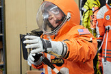 Space.com staff writer Miriam Kramer tries on Final Frontier Design's third generation spacesuit.