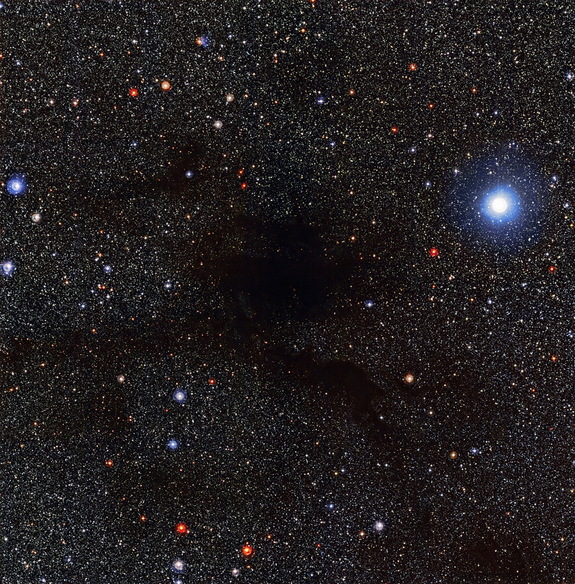 A dark cloud of gas called Lupus 4 blocks out more-distant stars. Photo released Sept. 3, 2014.
