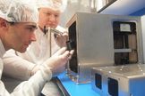 The world's first 3D printer headed for space, built by Made In Space, is assembled for its launch aboard a SpaceX Dragon spacecraft. Made In Space team members Mike Snyder and Jason Dunn are shown performing the work.