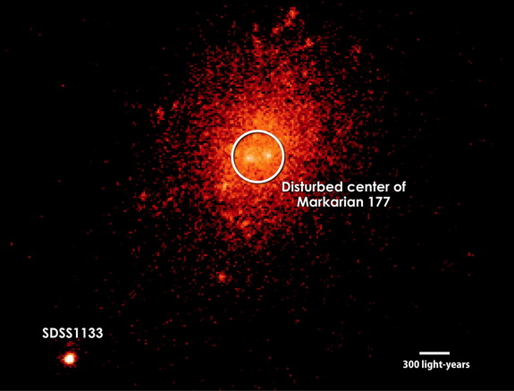 An image from the Keck II Telescope in Hawaii shows the dwarf galaxy Markarian 177, which may have once been two separate galaxies that merged together. The object SDSS1133 (bottom left) may be a black hole, ejected into space during the merger.