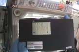 International Space Station commander Barry "Butch" Wilmore holds up the first 3D printed part made in space. The part, an extruder plate (a piece of the printer itself), was made on Nov. 24, 2014.