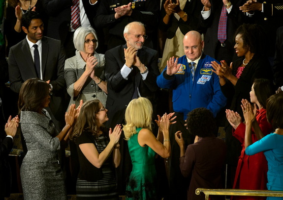 NASA astronaut Scott Kelly stands as he is recognized by President Barack Obama, while First lady Michelle Obama, front left, and other guests applaud, during the State of the Union address on Capitol Hill in Washington, Tuesday Jan. 20, 2015.