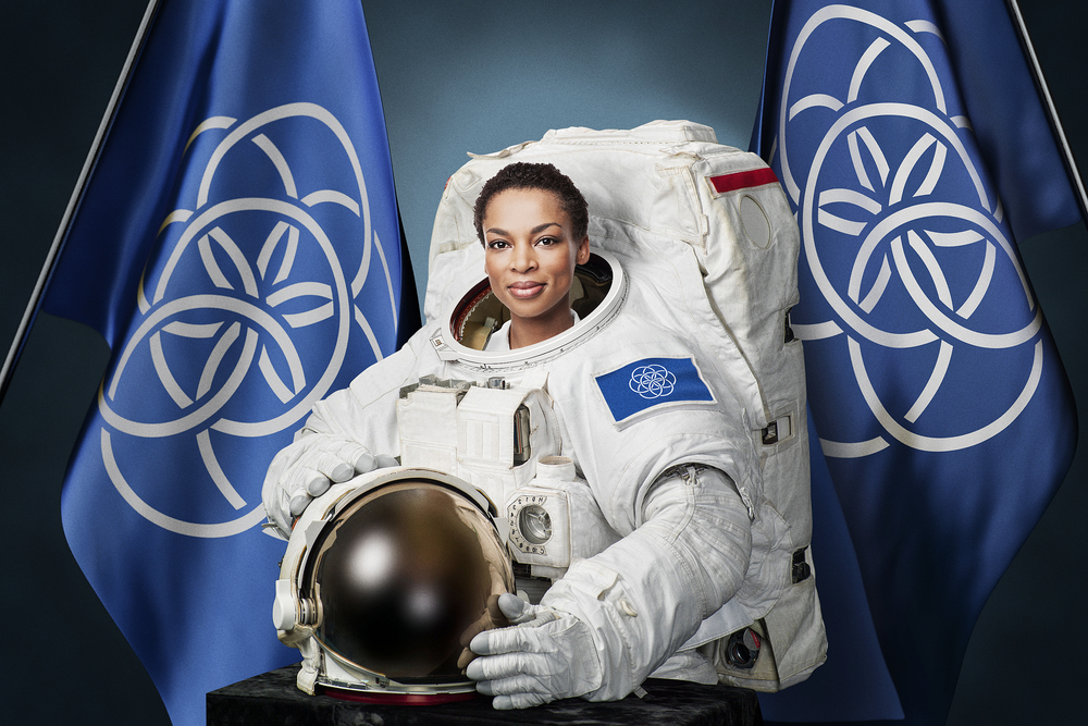 Astronaut Posing with Proposed International Flag of Planet Earth