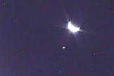 An image of Earth, taken by NASA's LCROSS satellite, shows the planet in its crescent phase. The smaller light to the left is the moon.