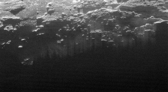 The setting sun illuminates fog or near-surface haze on Pluto in this small section of an image taken by NASA’s New Horizons probe on July 14, 2015, when it was 11,000 miles (18,000 kilometers) from the dwarf planet. The image covers a stretch of land 115 miles (185 km) wide.